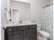 Well-lit bathroom featuring dark cabinetry, light countertops and a blue shower curtain at 143 Robinson Ridge Dr, Mooresville, NC 28117