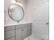 Bright bathroom vanity with granite countertops, double sinks, round mirror, and storage space at 143 Robinson Ridge Dr, Mooresville, NC 28117