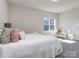 Bright bedroom with a comfortable bed, soft pillows, and a sunlit window at 143 Robinson Ridge Dr, Mooresville, NC 28117