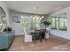 Bright dining area features large windows, modern lighting, area rug, and views of the backyard at 143 Robinson Ridge Dr, Mooresville, NC 28117