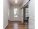 Bright foyer showcasing hardwood floors, modern lighting, and a stylish barn door at 143 Robinson Ridge Dr, Mooresville, NC 28117