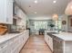 Modern kitchen with stainless appliances, white cabinets, and stone countertops, with the dining room visible at 143 Robinson Ridge Dr, Mooresville, NC 28117