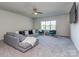 Spacious living room with a large sofa, ceiling fan and natural lighting at 143 Robinson Ridge Dr, Mooresville, NC 28117