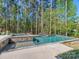 Backyard swimming pool and hot tub surrounded by a lush green forest at 143 Robinson Ridge Dr, Mooresville, NC 28117