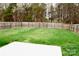 The backyard has a large lawn and a wood fence around the perimeter at 14608 Arlandes Dr, Charlotte, NC 28278