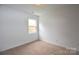 This bedroom has neutral carpet, a window, and is freshly painted at 14608 Arlandes Dr, Charlotte, NC 28278