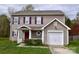 Charming two-story home with neutral siding, purple shutters, and a well-manicured front lawn at 14608 Arlandes Dr, Charlotte, NC 28278