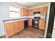 Efficient kitchen featuring wood cabinets, black appliances and durable grey countertops at 14608 Arlandes Dr, Charlotte, NC 28278