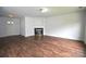 Spacious living room features wood-look flooring and fireplace, offering a cozy ambiance at 14608 Arlandes Dr, Charlotte, NC 28278