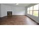 Bright living room with wood-look flooring, and a fireplace creating a cozy focal point at 14608 Arlandes Dr, Charlotte, NC 28278