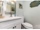 Bathroom featuring a white vanity with lots of space and a mirror with natural light at 147 Spring Shore Rd, Statesville, NC 28677