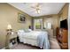 Cozy bedroom featuring a ceiling fan, neutral walls, and a comfortable bed with a floral quilt at 147 Spring Shore Rd, Statesville, NC 28677