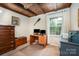 Functional bedroom as office, featuring wood ceiling beams, desk setup, and natural light from the window at 147 Spring Shore Rd, Statesville, NC 28677
