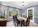 Charming dining room with wooden table, chandelier, and views to the backyard at 147 Spring Shore Rd, Statesville, NC 28677