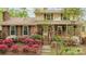 Inviting home with a brick facade, charming front porch, and colorful azalea bushes at 147 Spring Shore Rd, Statesville, NC 28677