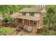 Charming brick home with a front porch, lush landscaping, and a welcoming curb appeal at 147 Spring Shore Rd, Statesville, NC 28677