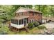 Charming brick home features a screened porch, deck and landscaped backyard with mature foliage at 147 Spring Shore Rd, Statesville, NC 28677