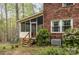 Exterior view showcases the screened porch, brick siding, and mature trees at 147 Spring Shore Rd, Statesville, NC 28677
