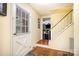 Bright entryway with hardwood floors and staircase leading to the upper level of the home at 147 Spring Shore Rd, Statesville, NC 28677