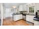 Bright kitchen featuring ample cabinet space, a kitchen island, and hardwood flooring at 147 Spring Shore Rd, Statesville, NC 28677