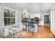 Eat-in kitchen featuring an island, black countertops, hardwood floors, and ample natural light at 147 Spring Shore Rd, Statesville, NC 28677