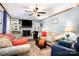 Comfortable living room with fireplace, built-in shelving, and ceiling fan at 147 Spring Shore Rd, Statesville, NC 28677