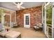 Inviting screened porch with comfortable seating and a ceiling fan, perfect for outdoor relaxation at 147 Spring Shore Rd, Statesville, NC 28677