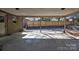 Covered back patio with views of the fenced backyard and mature trees at 165 Northwest Rd, Hickory, NC 28601