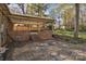 Brick patio of home with covered porch and backyard with mature trees at 165 Northwest Rd, Hickory, NC 28601