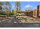 Backyard of home with covered patio and mature trees on a sunny day at 165 Northwest Rd, Hickory, NC 28601