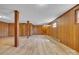 Spacious basement with paneled walls, wood columns, laminate flooring, and stairs at 165 Northwest Rd, Hickory, NC 28601