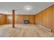 Finished basement features wood paneling, brick fireplace, and laminate flooring at 165 Northwest Rd, Hickory, NC 28601
