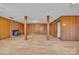 Spacious basement with wood paneling, vinyl floors, wood columns, and brick fireplace at 165 Northwest Rd, Hickory, NC 28601