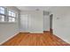 Well-lit bedroom featuring hardwood floors, closet, and entry door at 165 Northwest Rd, Hickory, NC 28601