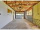 Unfinished garage with concrete floor, exposed insulation, and side access door at 165 Northwest Rd, Hickory, NC 28601