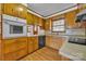 Traditional kitchen showcasing wood cabinets, neutral countertops, and white appliances at 165 Northwest Rd, Hickory, NC 28601