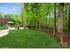 Expansive backyard with lush lawn, mature trees, and a charming patio area at 1813 Wedowee Ct, Rock Hill, SC 29732
