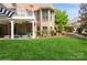 Expansive backyard featuring well-maintained lawn, brick patio, and covered seating area with outdoor furniture and manicured landscaping at 1813 Wedowee Ct, Rock Hill, SC 29732