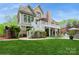 Expansive backyard with multi-level brick patio, complete with seating areas and manicured landscaping surrounding the property at 1813 Wedowee Ct, Rock Hill, SC 29732