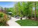 Inviting backyard patio with comfortable seating, an umbrella, and lush landscaping at 1813 Wedowee Ct, Rock Hill, SC 29732