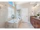 Bathroom featuring a glass shower, standalone tub with tile surround, and elegant fixtures at 1813 Wedowee Ct, Rock Hill, SC 29732