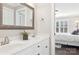 Bathroom featuring dual sinks with white cabinets, a large mirror, and access to a bedroom at 1813 Wedowee Ct, Rock Hill, SC 29732