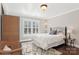 Bedroom with hardwood floors, neutral paint, and plantation shutters, and a patterned area rug at 1813 Wedowee Ct, Rock Hill, SC 29732