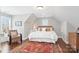 Bedroom with hardwood floors, neutral paint, and a large window with window box at 1813 Wedowee Ct, Rock Hill, SC 29732