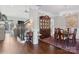 Formal dining room with hardwood floors, a chandelier, china cabinet, and staircase visible from the entryway at 1813 Wedowee Ct, Rock Hill, SC 29732