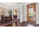 Elegant dining room featuring a wooden table, chandelier, hardwood floors, and a stained-glass front door at 1813 Wedowee Ct, Rock Hill, SC 29732