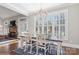 Dining room with a chandelier, plantation shutters, and a view into a cozy seating area at 1813 Wedowee Ct, Rock Hill, SC 29732
