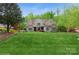 Charming home features a well-manicured lawn and inviting stone and shingle exterior with blue shutters at 1813 Wedowee Ct, Rock Hill, SC 29732