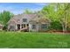 Charming home with lush front yard, stone and shingle exterior, and lovely landscaping at 1813 Wedowee Ct, Rock Hill, SC 29732