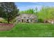 Charming home with a well-manicured front lawn, beautiful landscaping, and stone accents at 1813 Wedowee Ct, Rock Hill, SC 29732